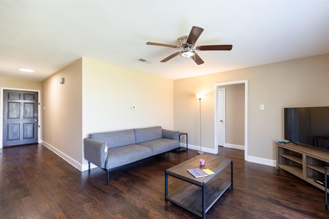 living area with ceiling fan, visible vents, baseboards, and wood finished floors