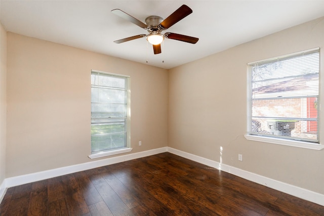 unfurnished room featuring dark wood finished floors, baseboards, and ceiling fan