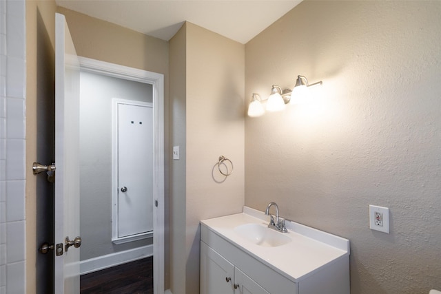 bathroom with vanity and a textured wall