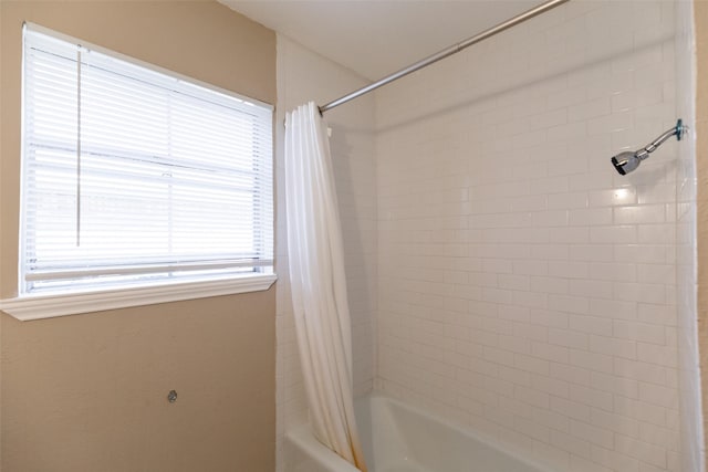 bathroom with shower / bath combination with curtain