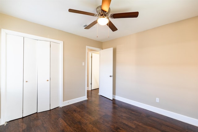 unfurnished bedroom with visible vents, baseboards, dark wood finished floors, a closet, and a ceiling fan