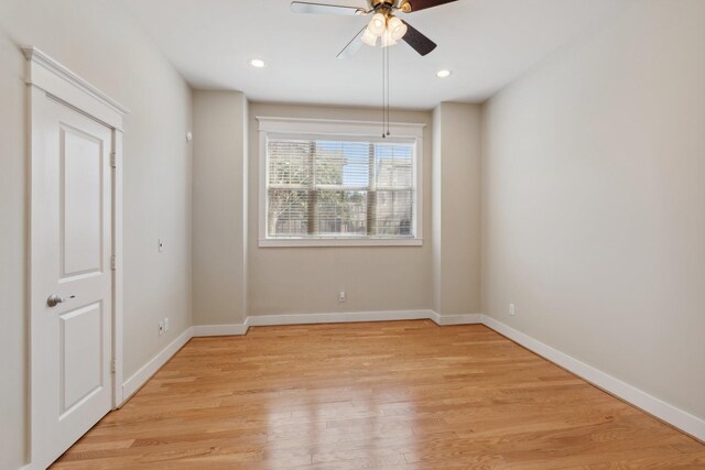 empty room with recessed lighting, light wood-style flooring, and baseboards