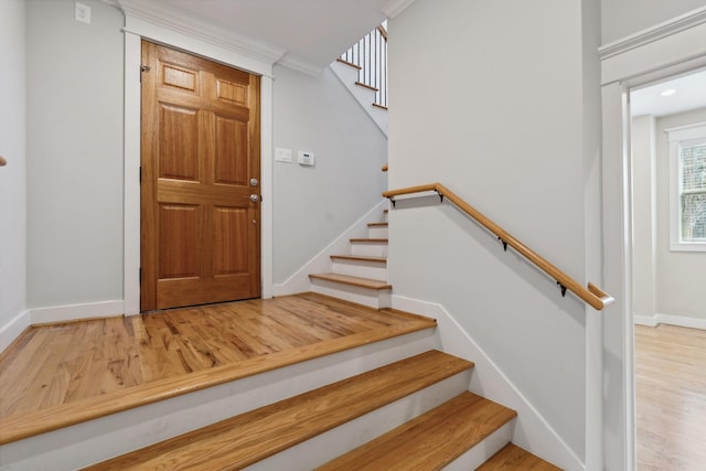 stairway featuring baseboards and wood finished floors