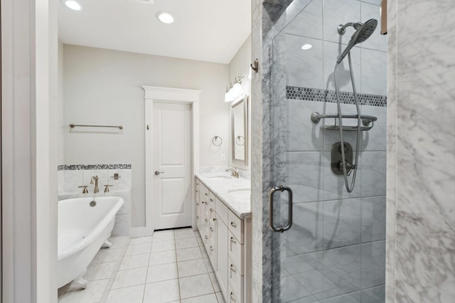 bathroom with a freestanding tub, a sink, a shower stall, tile patterned flooring, and double vanity