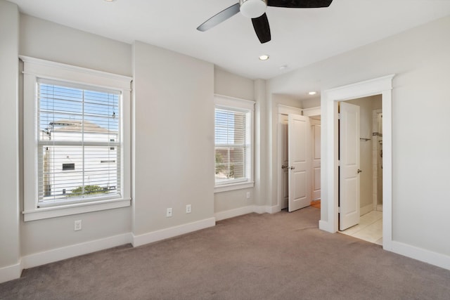 unfurnished bedroom with connected bathroom, recessed lighting, baseboards, and light carpet