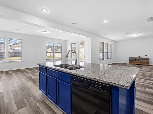 kitchen with a kitchen island with sink, a sink, black dishwasher, blue cabinets, and open floor plan