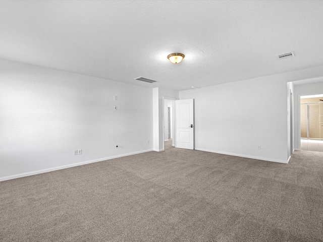 unfurnished room featuring visible vents, a textured ceiling, and carpet floors