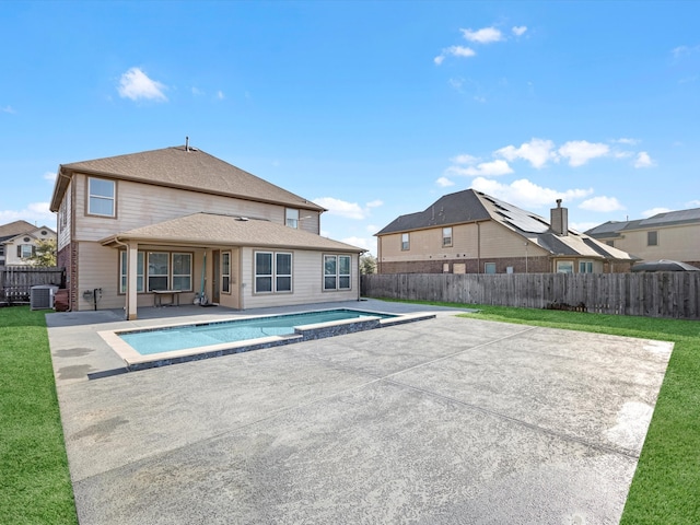 rear view of property with central air condition unit, a patio, and a fenced backyard