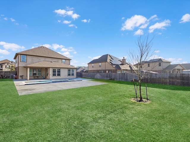 back of property with a yard, a patio, a fenced in pool, and a fenced backyard