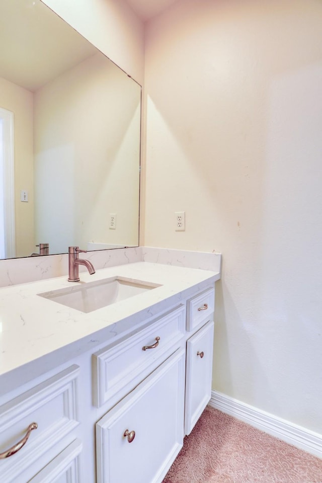 bathroom featuring baseboards and vanity