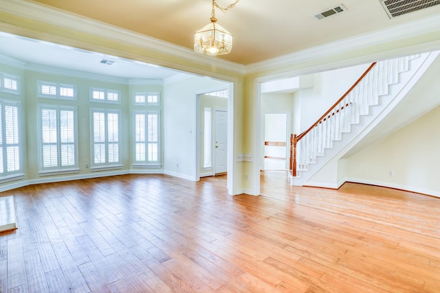 unfurnished living room with visible vents, light wood-style floors, ornamental molding, and stairway