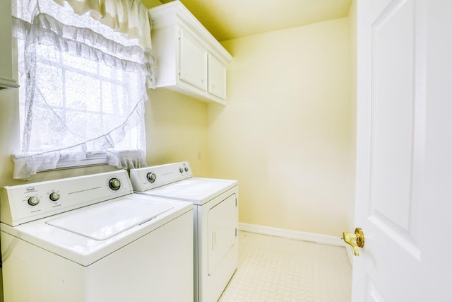 laundry area featuring cabinet space, independent washer and dryer, and baseboards