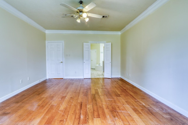 unfurnished bedroom featuring visible vents, connected bathroom, crown molding, baseboards, and light wood-style floors