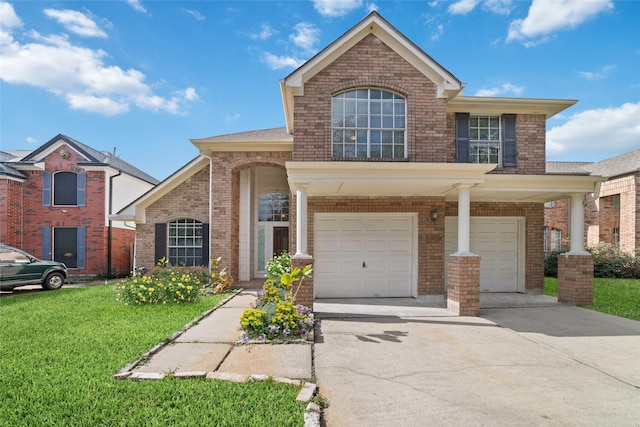 traditional-style home featuring driveway, a front yard, and brick siding