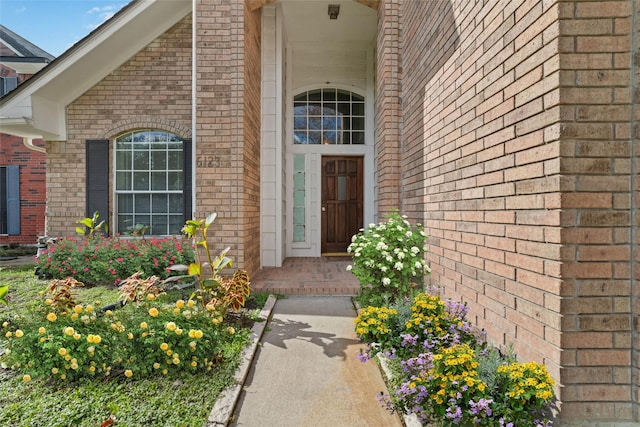 property entrance with brick siding