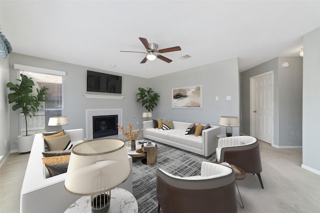 living area with light carpet, a fireplace, visible vents, a ceiling fan, and baseboards