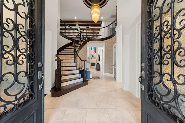 entryway featuring baseboards, stairs, a high ceiling, and recessed lighting