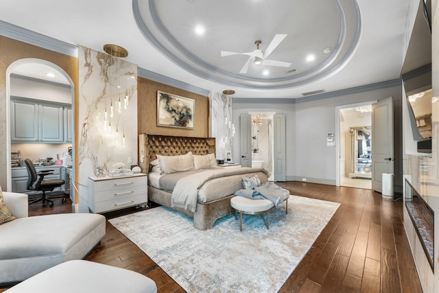 5006 Water View Bnd, Sugar Land, TX 77479 - bedroom with a raised ceiling, crown molding, an office area, dark wood-style flooring, and connected bathroom
