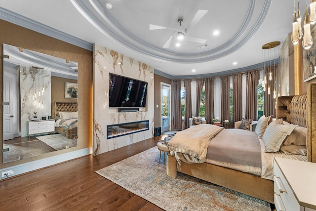 5006 Water View Bnd, Sugar Land, TX 77479 - bedroom with a tray ceiling, crown molding, wood finished floors, and a fireplace