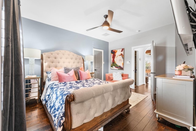 bedroom with visible vents, dark wood finished floors, and a ceiling fan