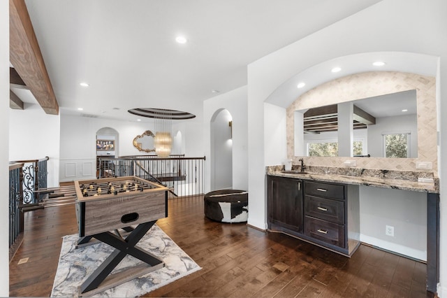 recreation room featuring recessed lighting, dark wood finished floors, and a sink