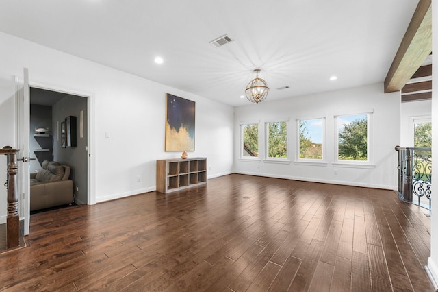 unfurnished living room featuring plenty of natural light, visible vents, and dark wood finished floors