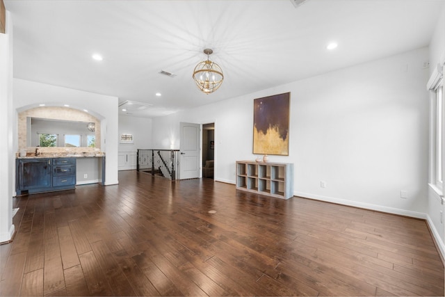 5006 Water View Bnd, Sugar Land, TX 77479 - unfurnished living room with dark wood-style floors, baseboards, recessed lighting, a chandelier, and a sink