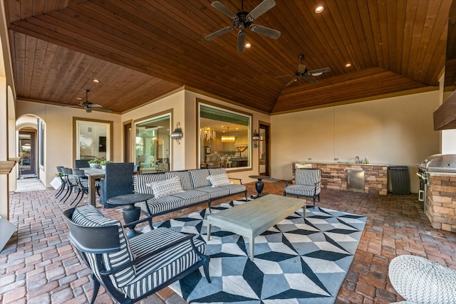 view of patio / terrace featuring outdoor dining area, ceiling fan, and an outdoor kitchen