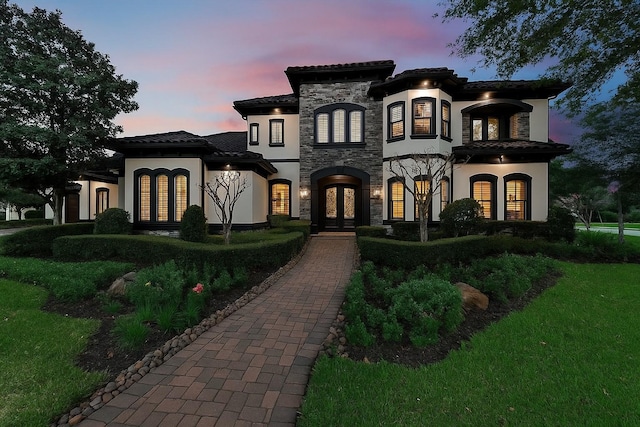 5006 Water View Bnd, Sugar Land, TX 77479 - view of front of property featuring french doors, stucco siding, stone siding, a tile roof, and a front yard