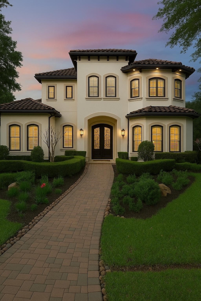 5006 Water View Bnd, Sugar Land, TX 77479 - mediterranean / spanish-style house featuring a tiled roof, stucco siding, and french doors