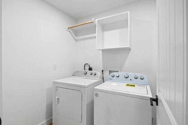 clothes washing area featuring washer and dryer and laundry area