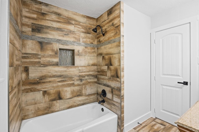 full bath with baseboards, bathing tub / shower combination, and a textured ceiling