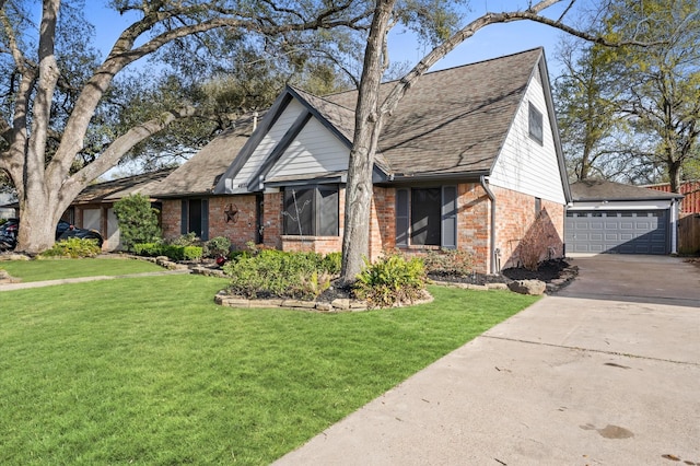 view of front facade featuring a front yard, a garage, brick siding, and roof with shingles