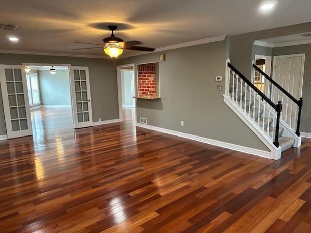 unfurnished living room featuring visible vents, stairway, and wood finished floors