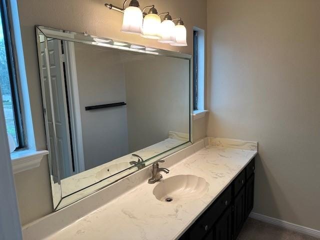 bathroom with baseboards and vanity