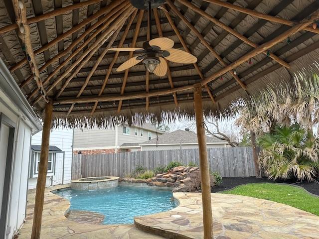 view of pool featuring a patio area, a fenced backyard, a ceiling fan, and a gazebo