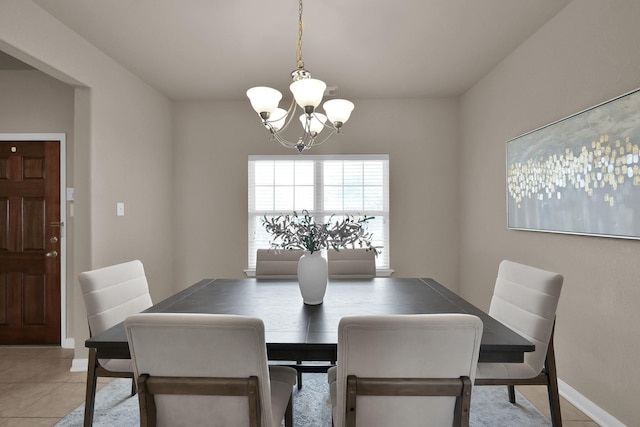 dining area featuring baseboards, light tile patterned floors, and an inviting chandelier