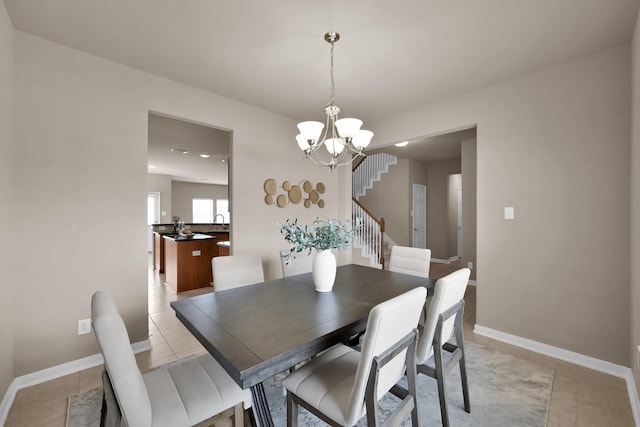 dining room with stairs, light tile patterned flooring, an inviting chandelier, and baseboards