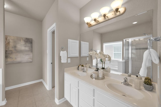 bathroom featuring tile patterned flooring, baseboards, a sink, and a shower stall