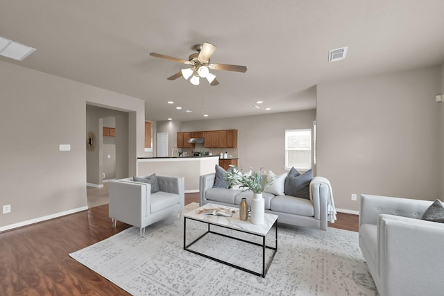 living area featuring recessed lighting, baseboards, and wood finished floors