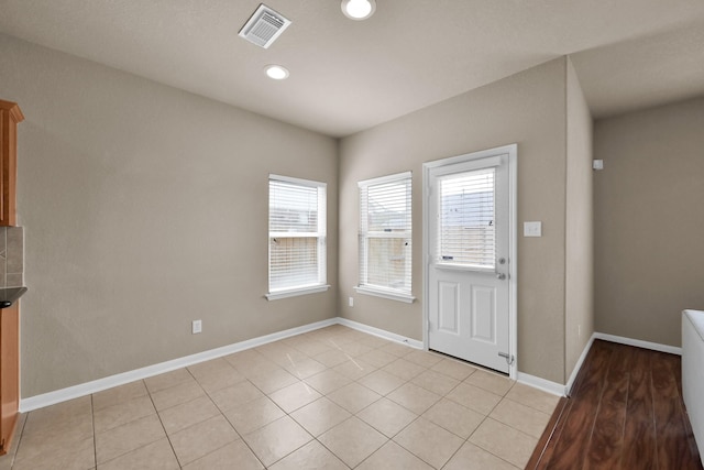 interior space with recessed lighting, visible vents, baseboards, and light tile patterned floors