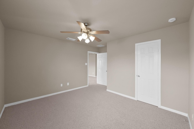 unfurnished bedroom featuring carpet floors, baseboards, visible vents, and a ceiling fan