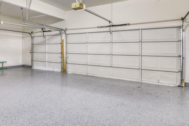 garage with baseboards and a garage door opener