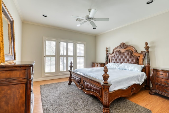 bedroom with light wood finished floors, ornamental molding, and a ceiling fan