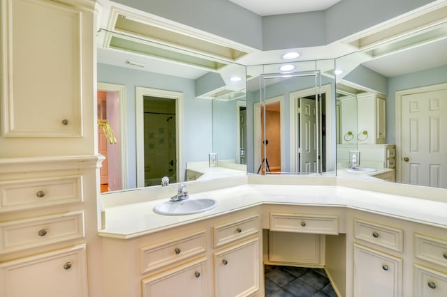 bathroom with a shower, tile patterned flooring, visible vents, and vanity