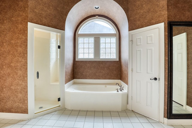 bathroom with wallpapered walls, a shower stall, a bath, and tile patterned floors