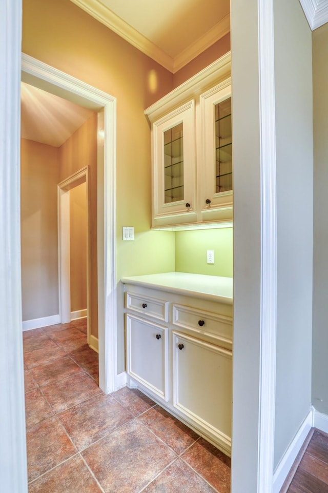 bar with ornamental molding and baseboards