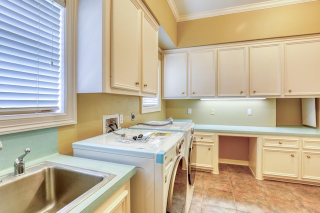 clothes washing area featuring a sink, ornamental molding, washing machine and dryer, and cabinet space