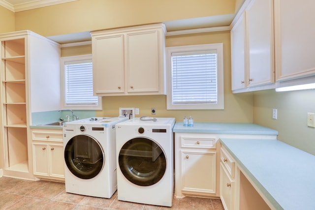 washroom with cabinet space, ornamental molding, a healthy amount of sunlight, a sink, and independent washer and dryer