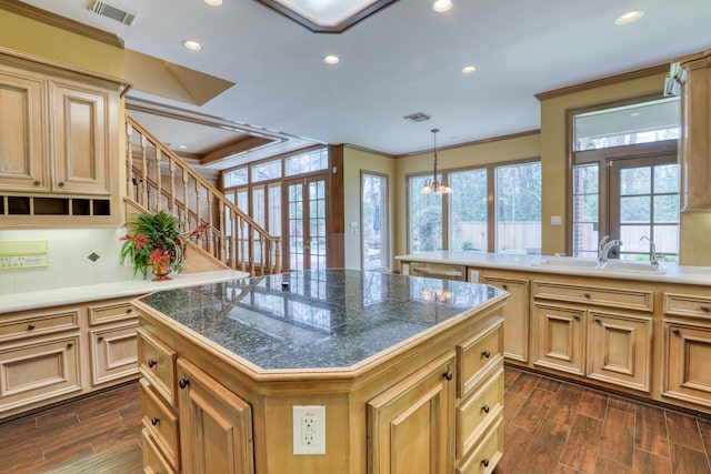 kitchen featuring tile counters, wood finish floors, visible vents, and a sink